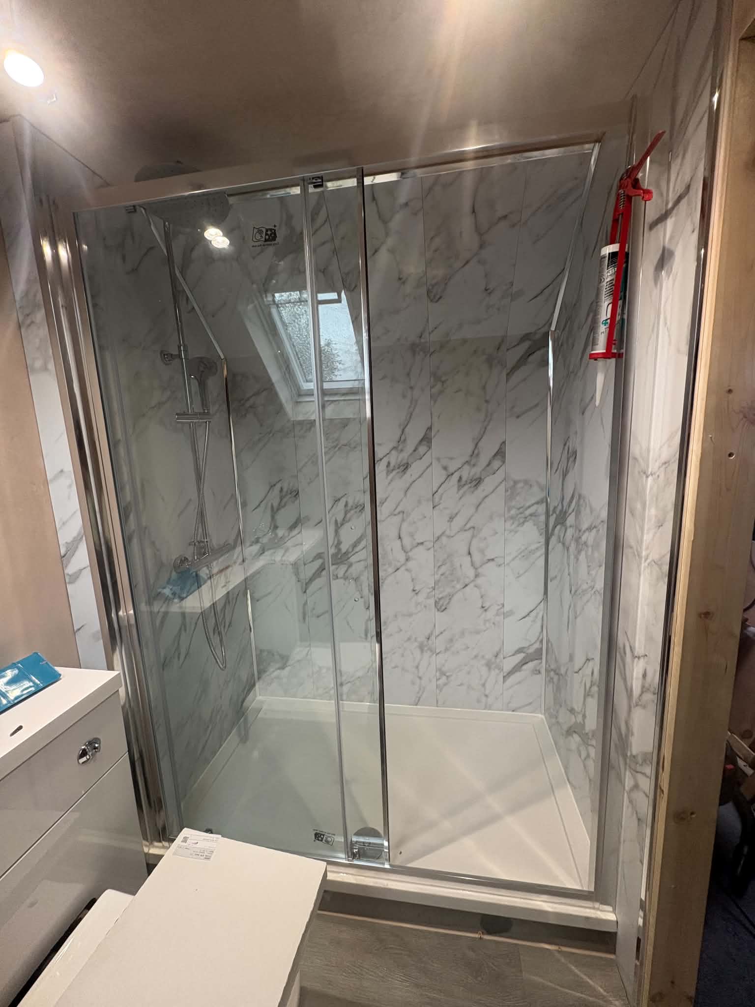 Marble walk-in shower with sliding door, Ponteland